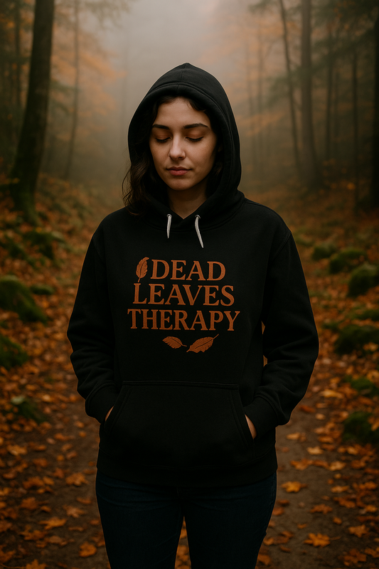 Person wearing a hoodie with 'Dead Leaves Therapy' text in a forest setting