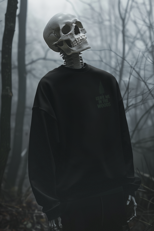 Person wearing a black sweatshirt with text in a forest setting