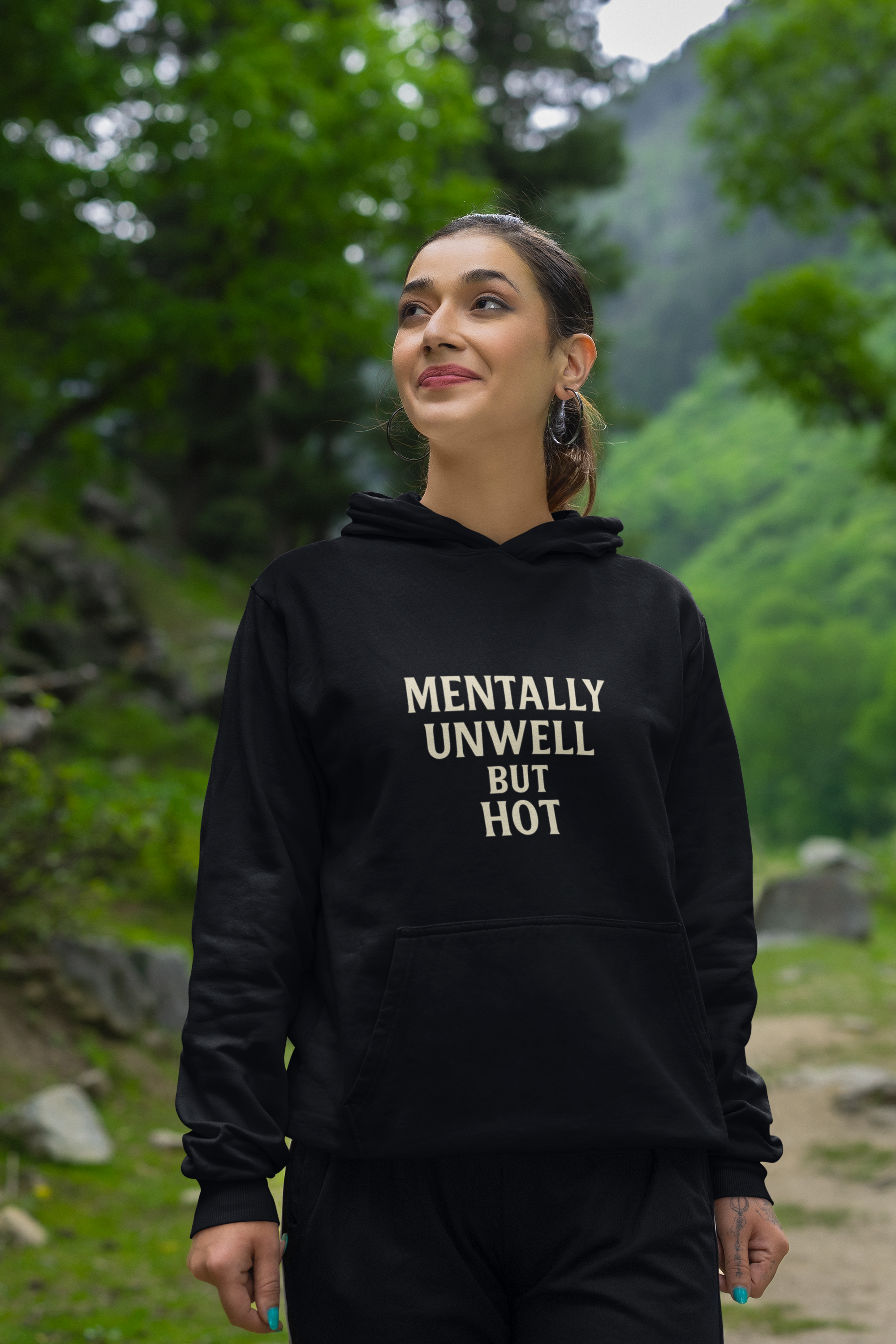 Woman wearing black "Mentally Unwell but Hot" hoodie outdoors
